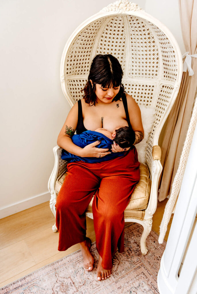 mother in Phoenix breastfeeding, like she would in lactation consult, for newborn photos