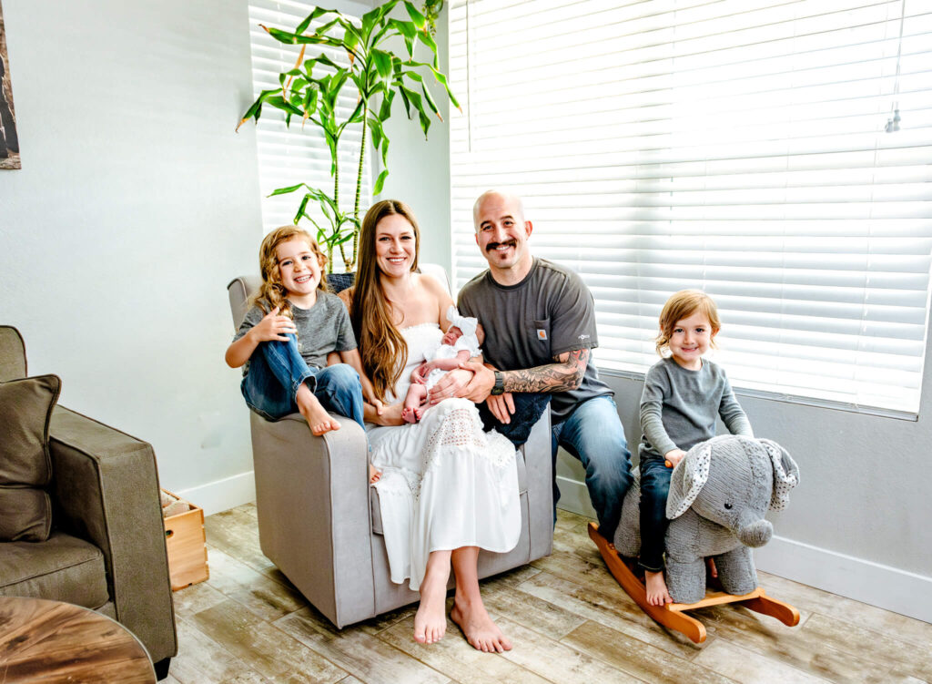 lactation consultants in Phoenix help Phoenix family posing for portrait in their home