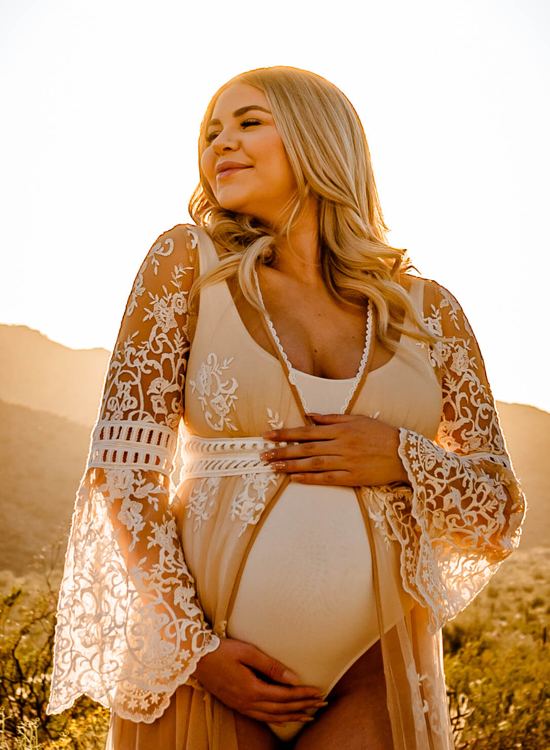 pregnant mom holding her belly while talking about finding a midwife in arizona