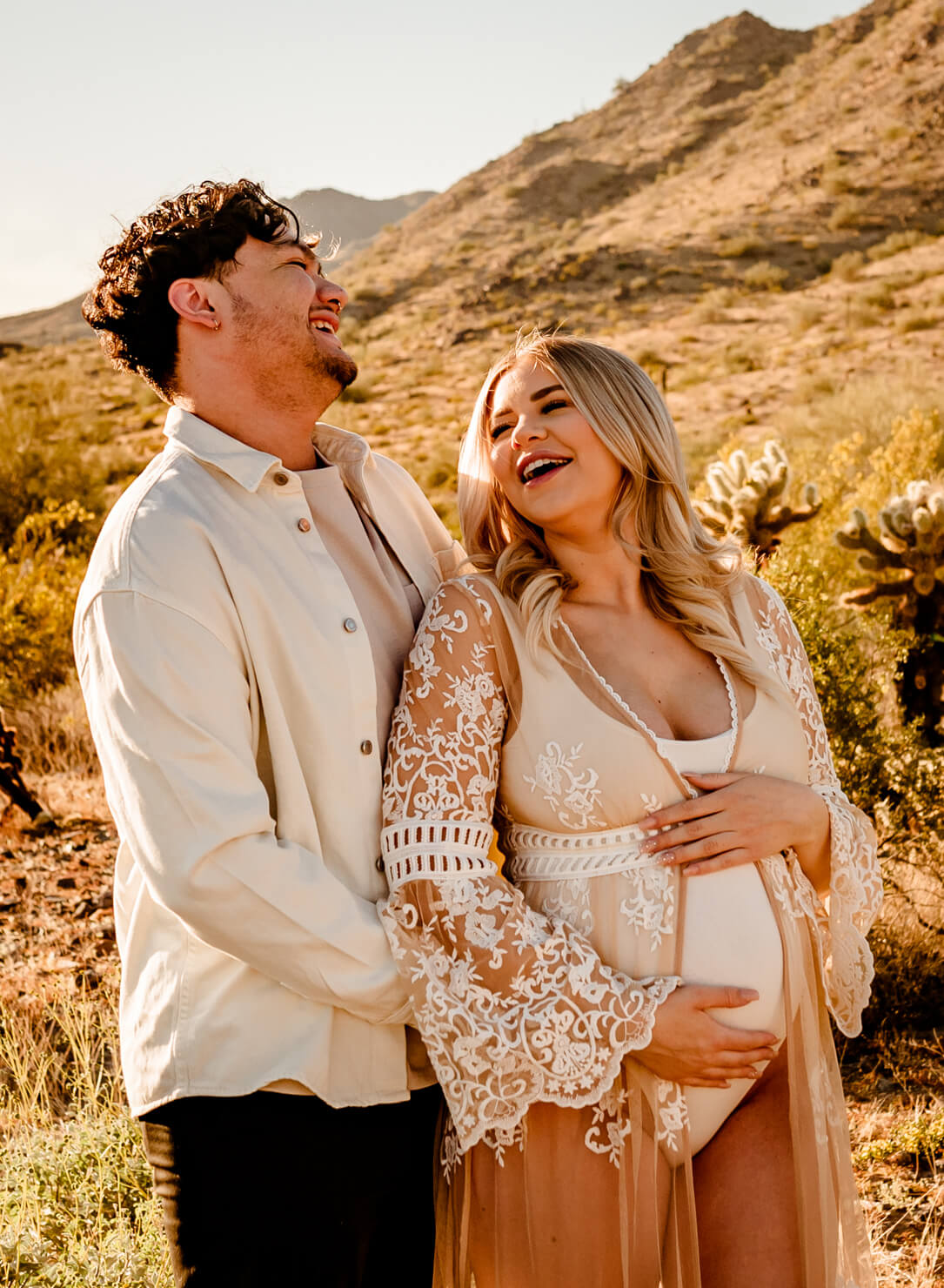 parents, who used an Arizona midwife, laughing and hugging for maternity portraits