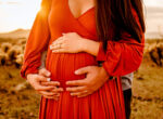 parents hands on baby bump baby bloom ultrasound