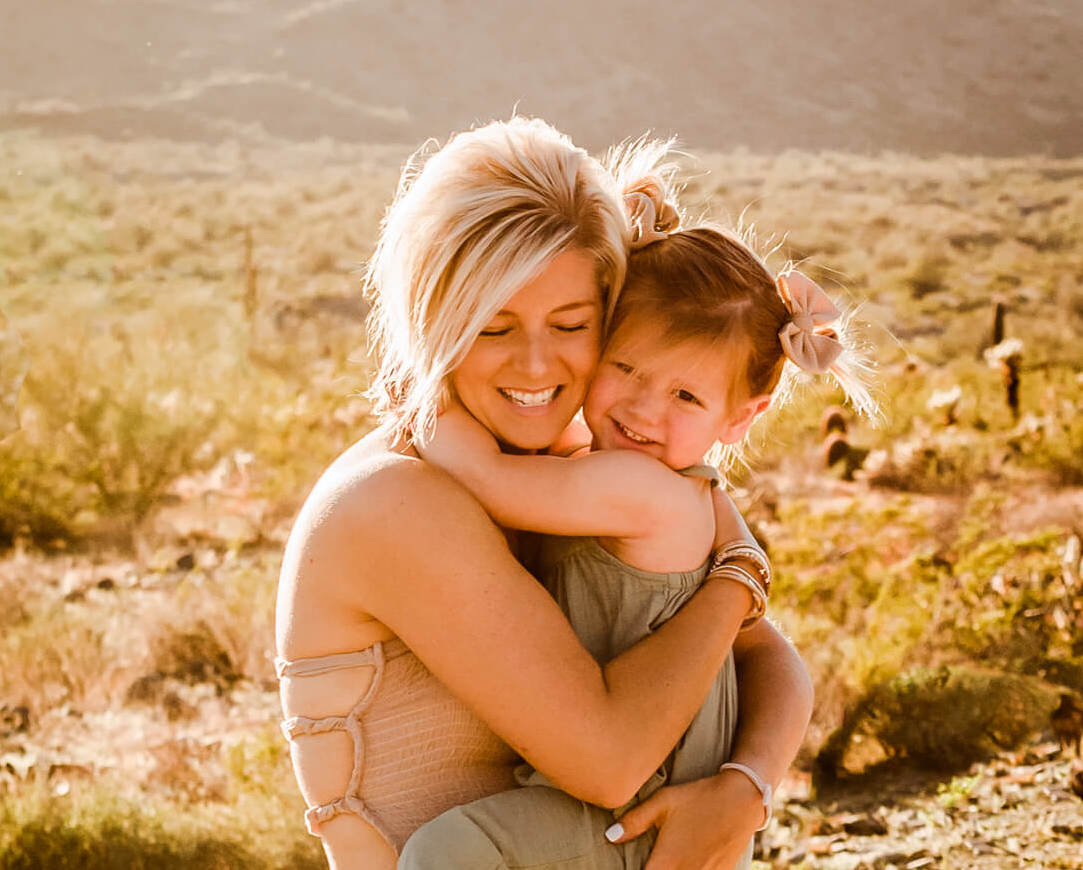 mom hugging daughter with pigtail bows from basically bows and bowties boutique