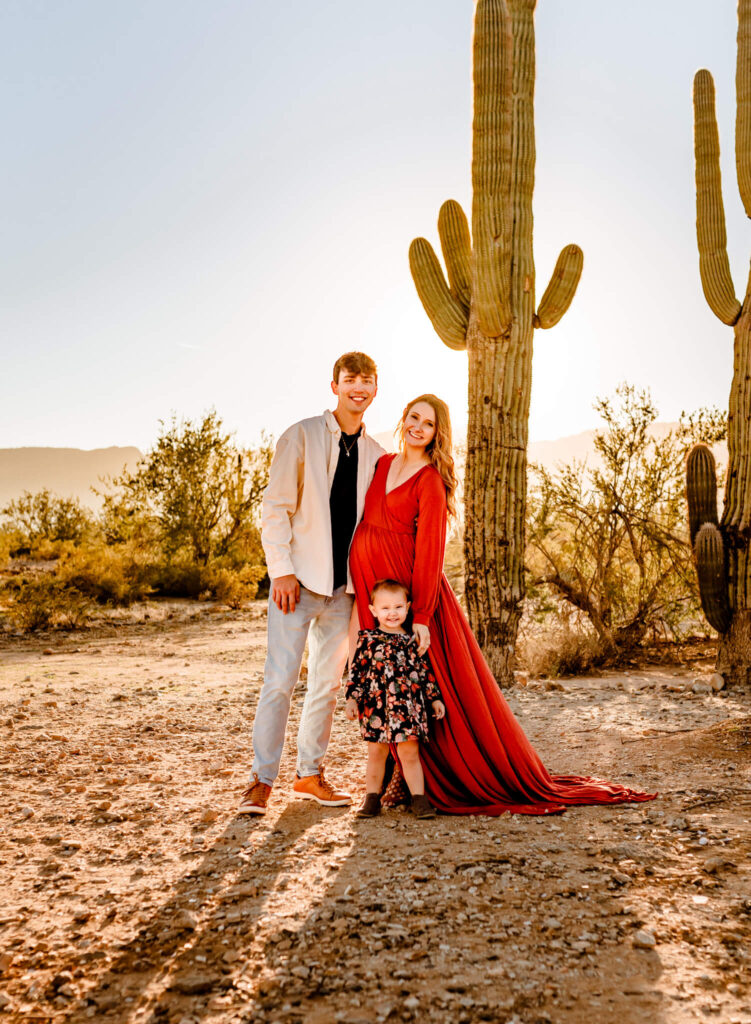 family smiling, posing during portrait session with surprise az family photographer Amber