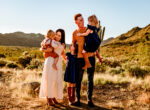 family playing in the desert in styles like cricket and ruby sells