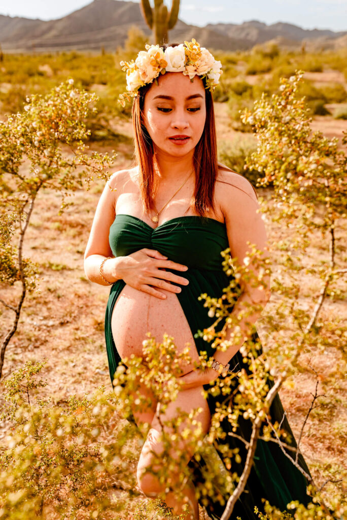 mom in green gown with baby bump exposed premier care for women