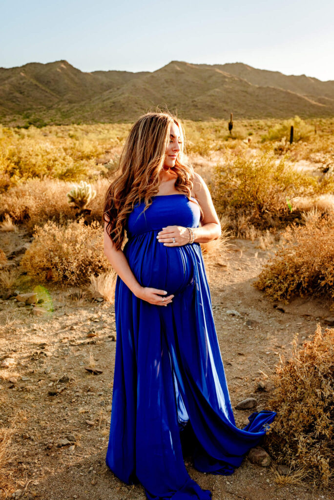 mom to be in blue dress who went to the motherhood co for prenatal care. By Cactus & Pine Photography LLC