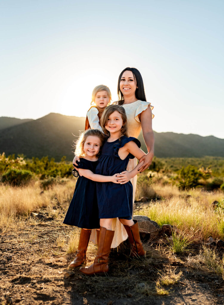 photography business coach helped photographer capture this photo of a mom with her daughters