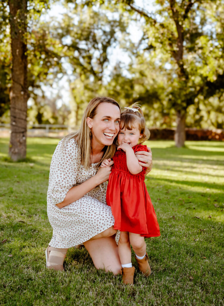 mother and daughter hugging and smiling, photography business coach