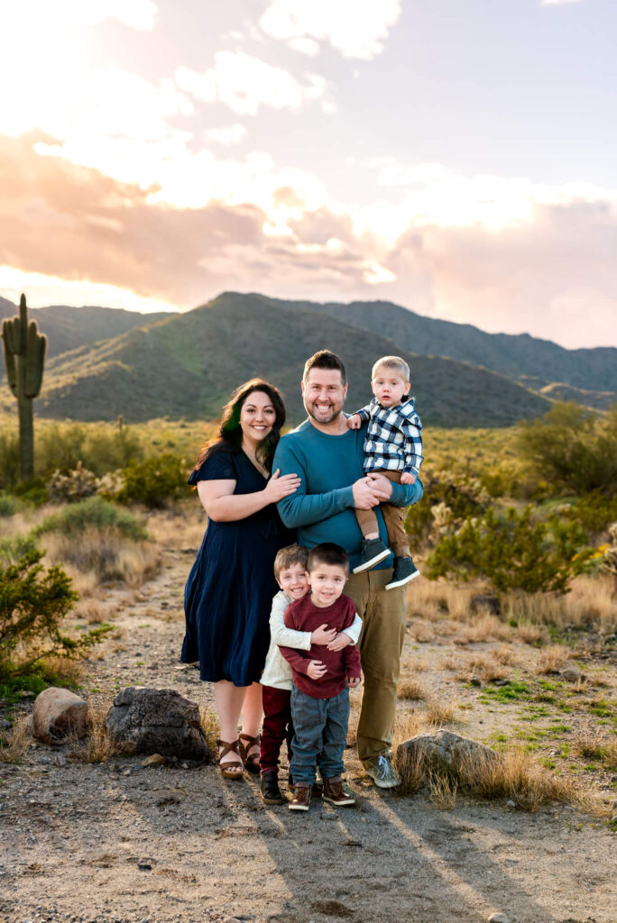 family smiling in desert scene, quality work from photography business coach advice