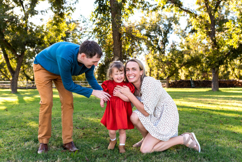 young family playing and smiling before apple picking in Phoenix AZ