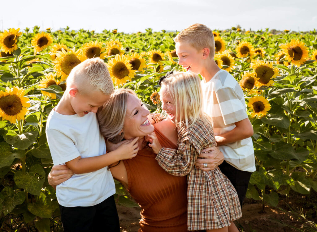 mom playing with her three children near a corn maze in Arizona