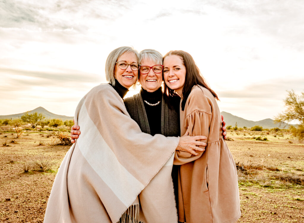 portrait at fall festival in Phoenix with 3 generations hugging