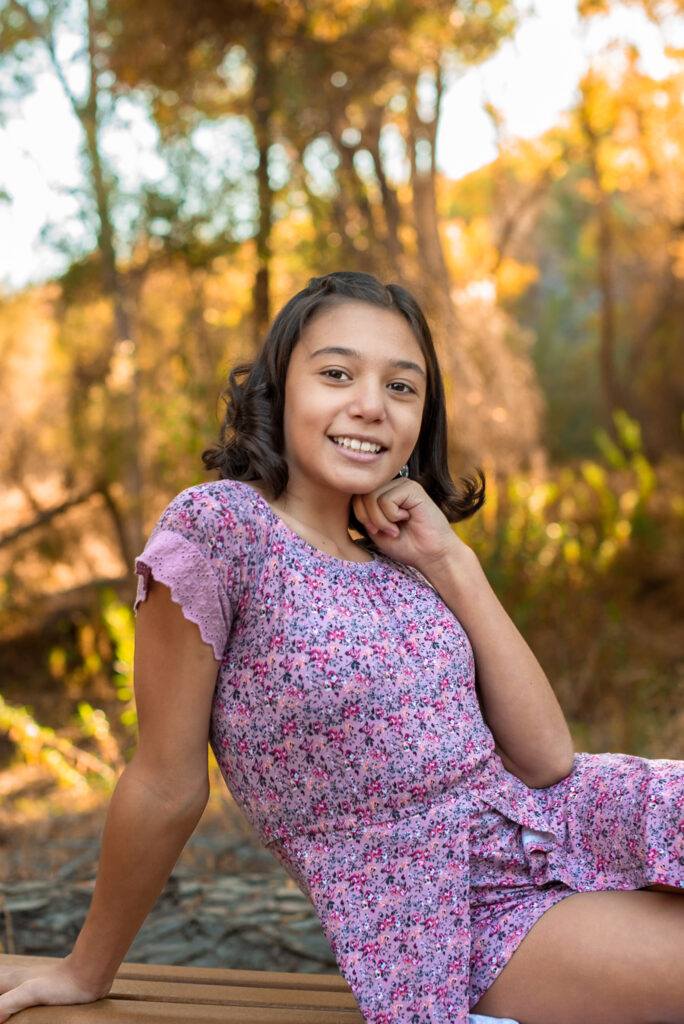 girl in forest showing fall festivals in Phoenix, AZ colors