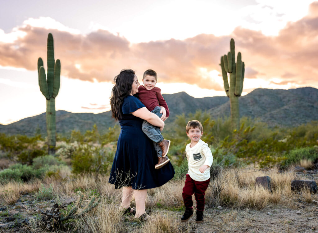 mom laughing with her sons in desert about christmas festivals in phoenix