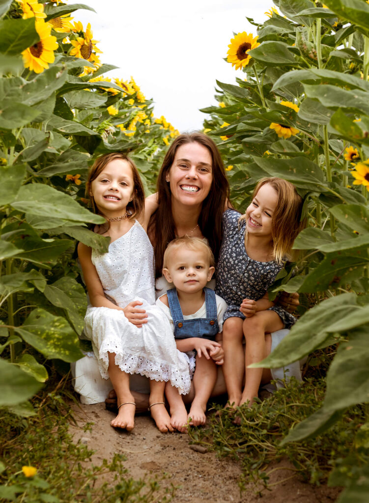 mom and kids playing in sunflowers as part of fall activities in Phoenix
